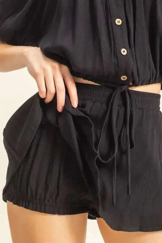 Drawstring hem short sleeve top and skort set in black with buttoned and ruched details.