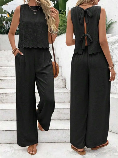 Tie back round neck top and pants set in black, featuring a bow design and sleeveless top with wide leg pants.