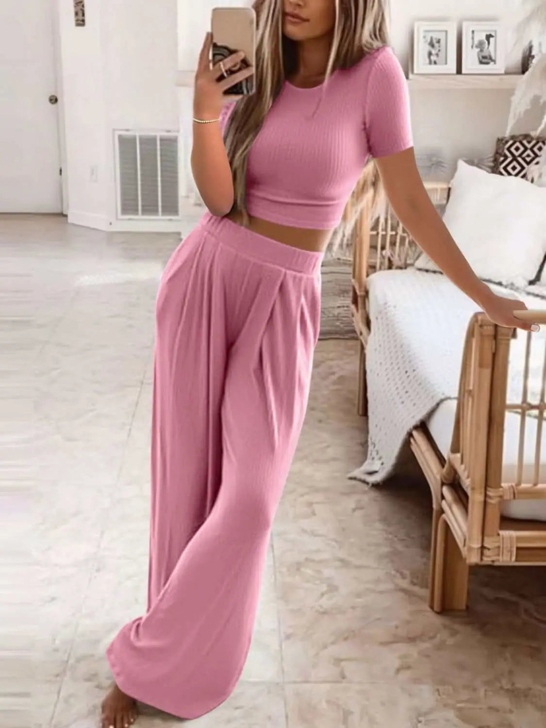 Plus size pink round neck short sleeve top and pants set model.