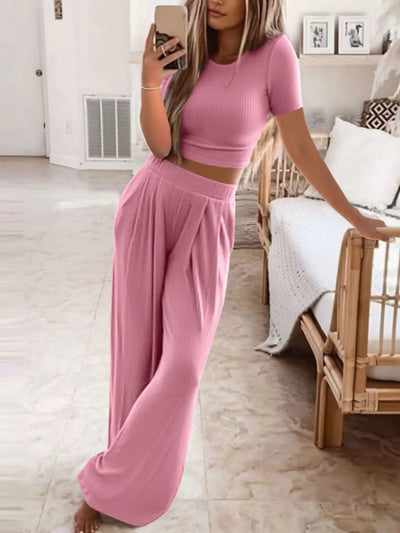 Plus size pink round neck short sleeve top and pants set model.