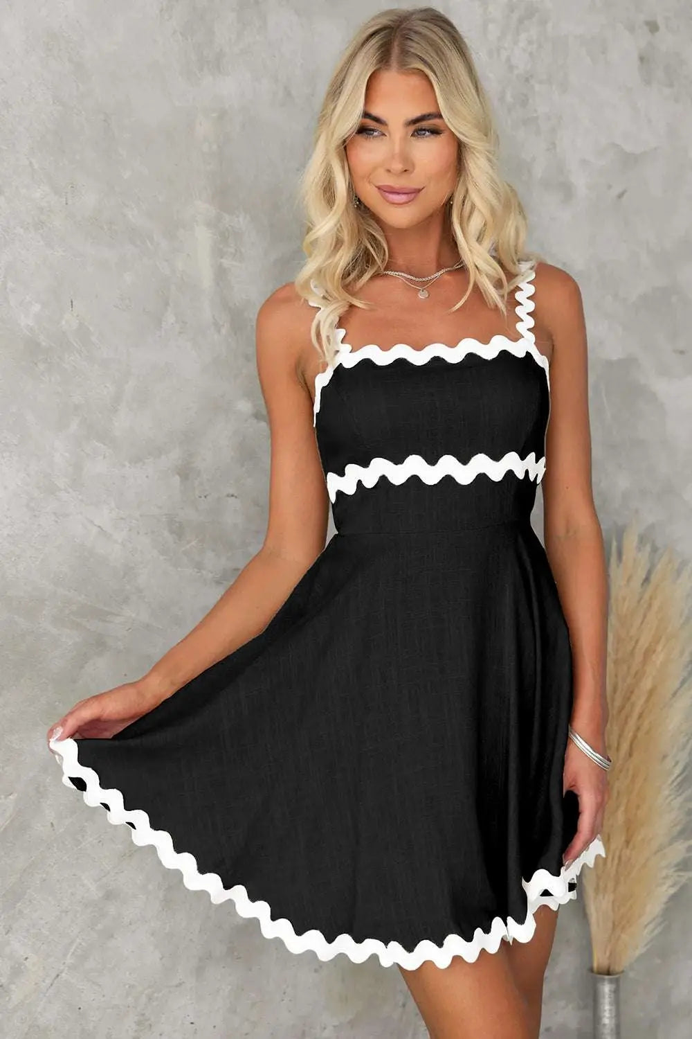 Front view of black square neck mini dress showcasing its classic silhouette and flattering fit