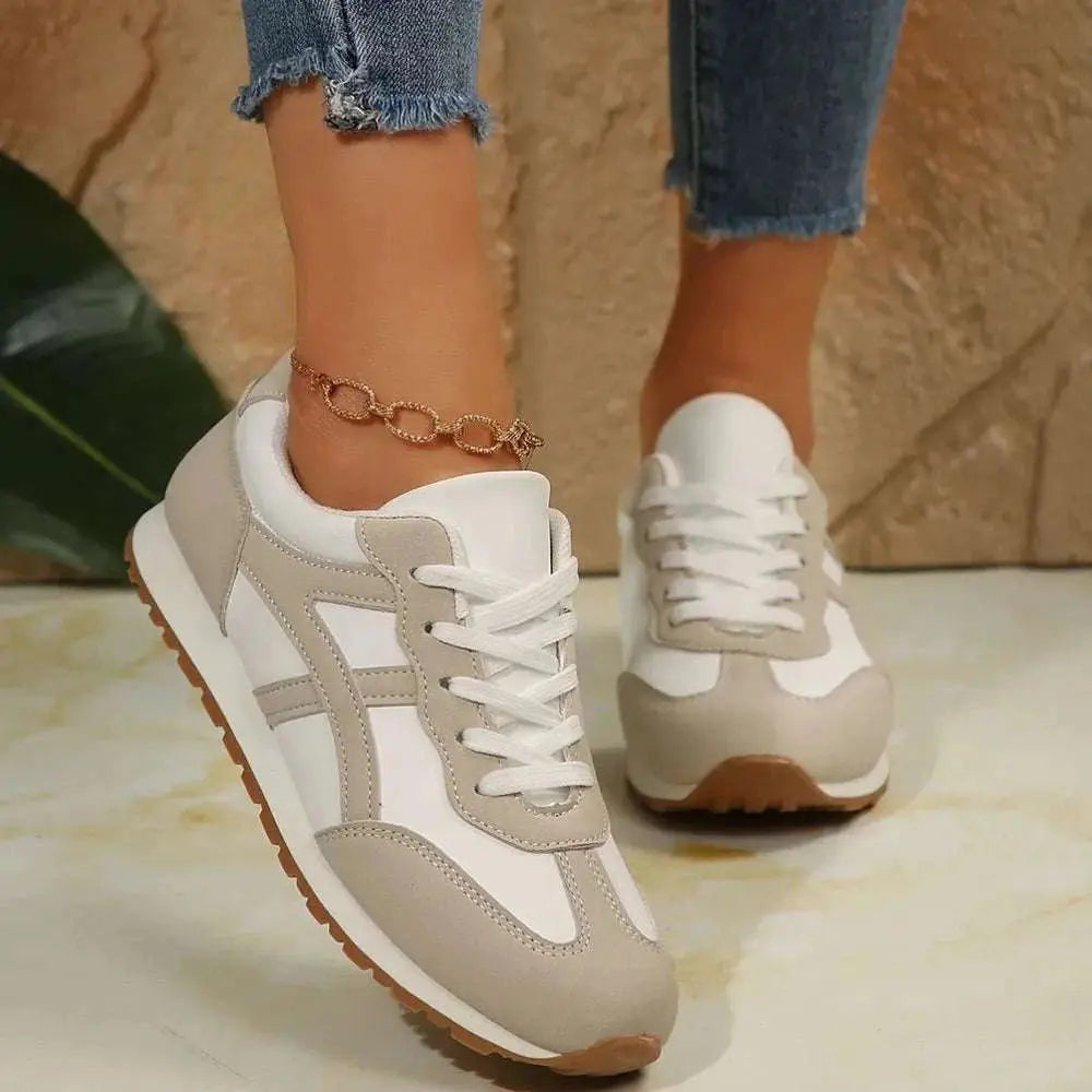 Contrast lace up round toe sneakers in beige and white with flat heels, made from PU leather and rubber.