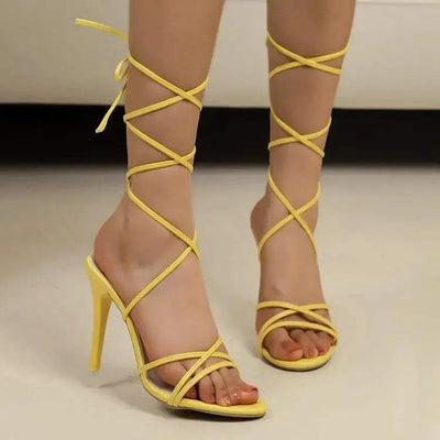 Yellow cross strap stiletto sandals with high heels and PU leather material.