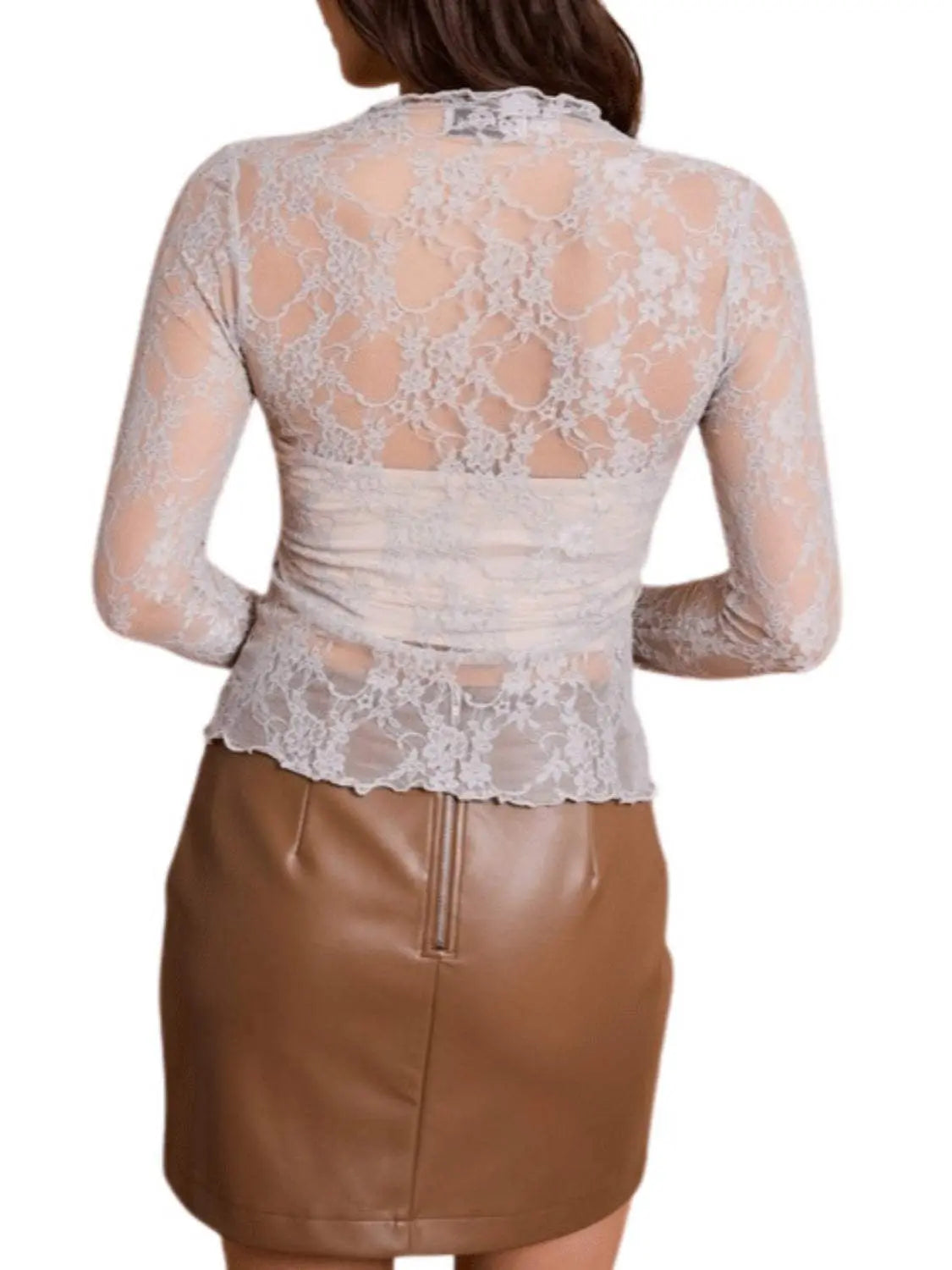 Lace mock neck long sleeve top with a sheer design paired with a brown skirt.