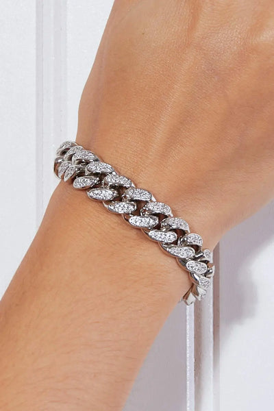 Curb chain bracelet made of brass on a person’s wrist.
