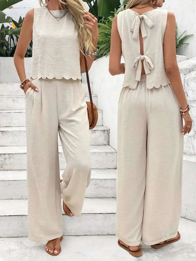 Tie back round neck top and pants set in beige, featuring bow detail and sleeveless design.
