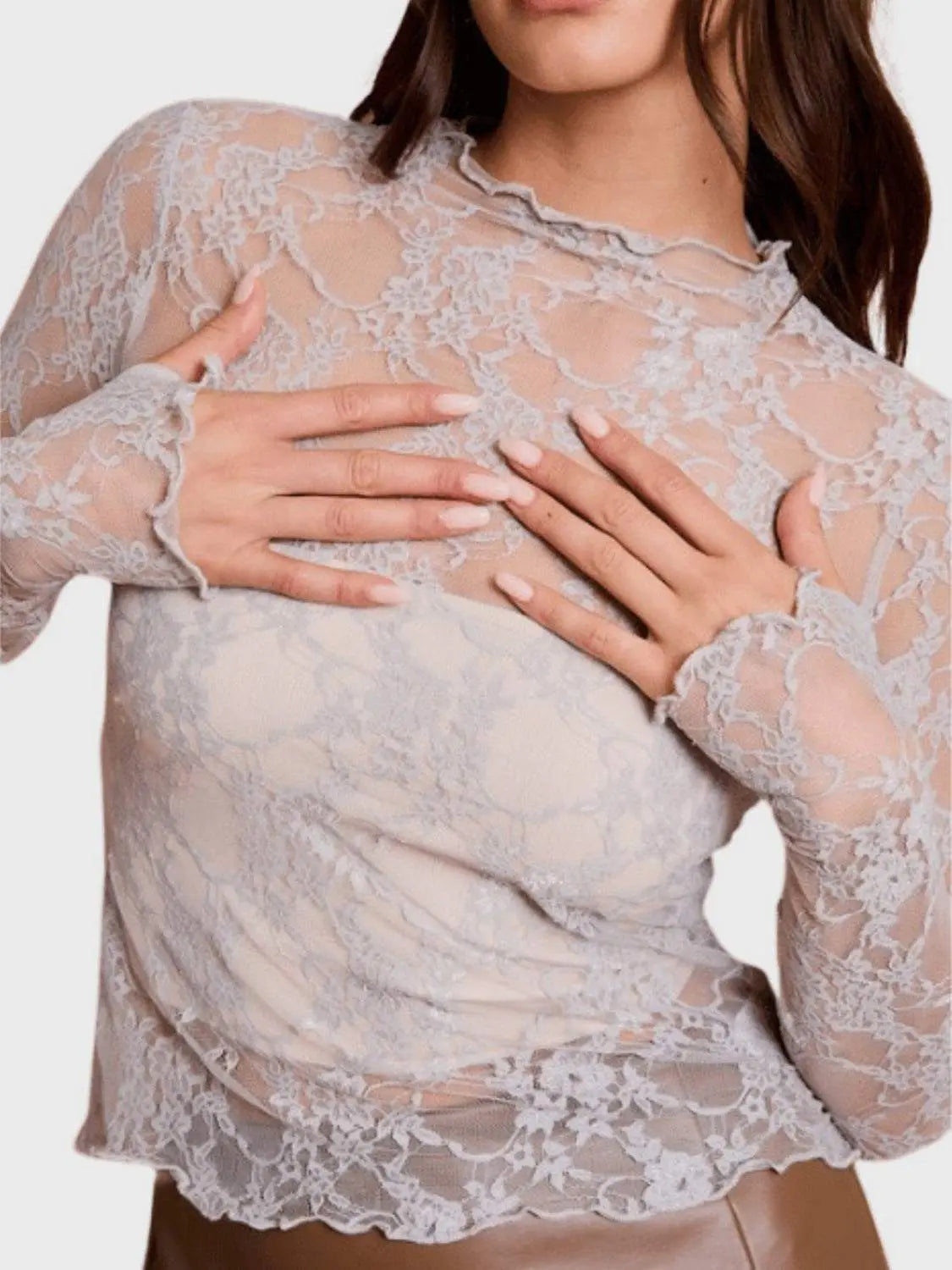 Lace mock neck long sleeve top in sheer fabric with a slightly stretchy fit.