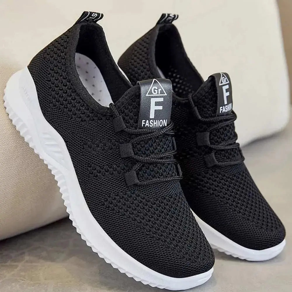 Breathable mesh lace-up athletic shoes in black with white soles.