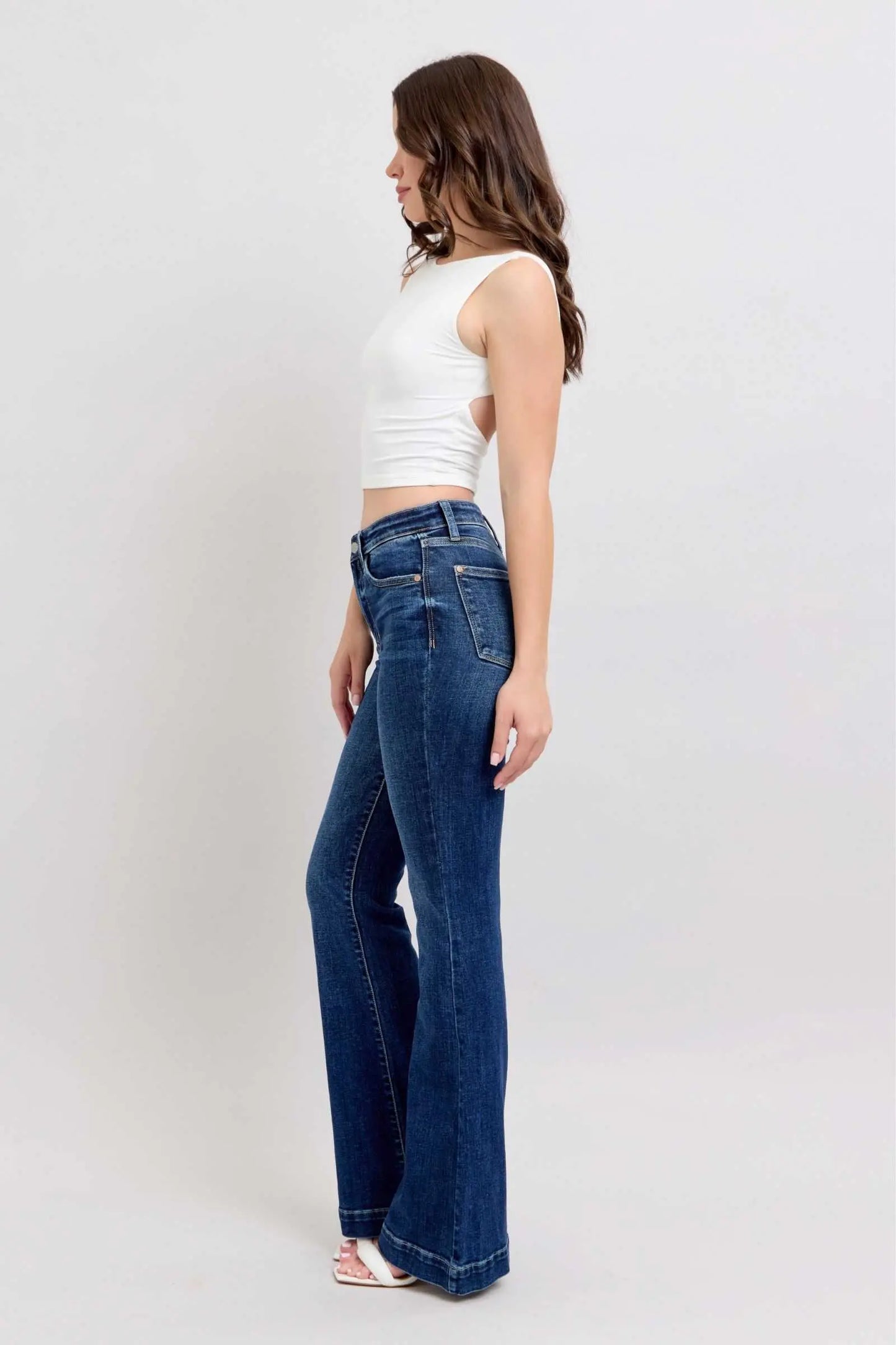 Judy Blue Full Size High Rise Flare Jeans with Pockets Plus Size, model wearing dark wash denim.