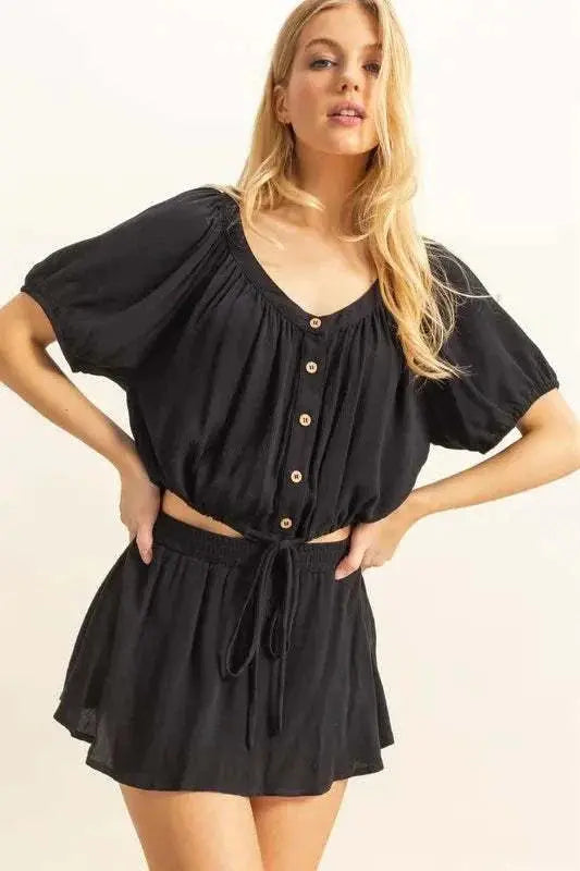 Women's drawstring hem short sleeve top and skort set, trendy black ensemble.
