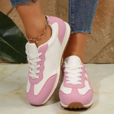 Contrast lace up round toe sneakers in pink and white with flat heel, made of PU leather and rubber.