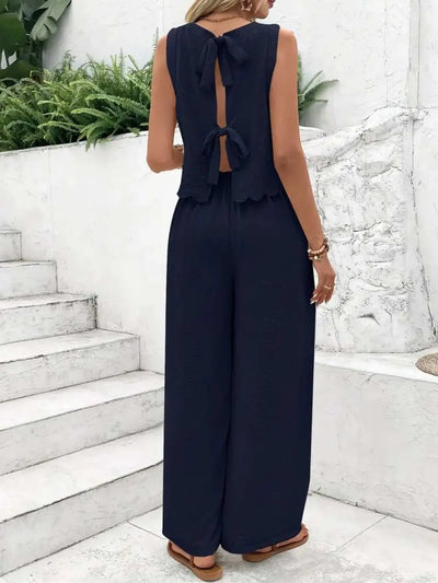 Tie back round neck top and pants set in navy blue, featuring bow details, sleeveless design, and no stretch fabric.