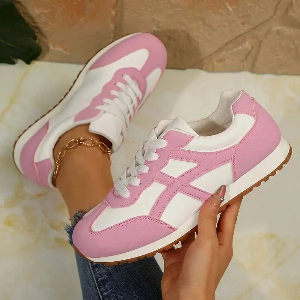Contrast lace up round toe sneakers in pink and white, featuring PU leather and rubber materials.
