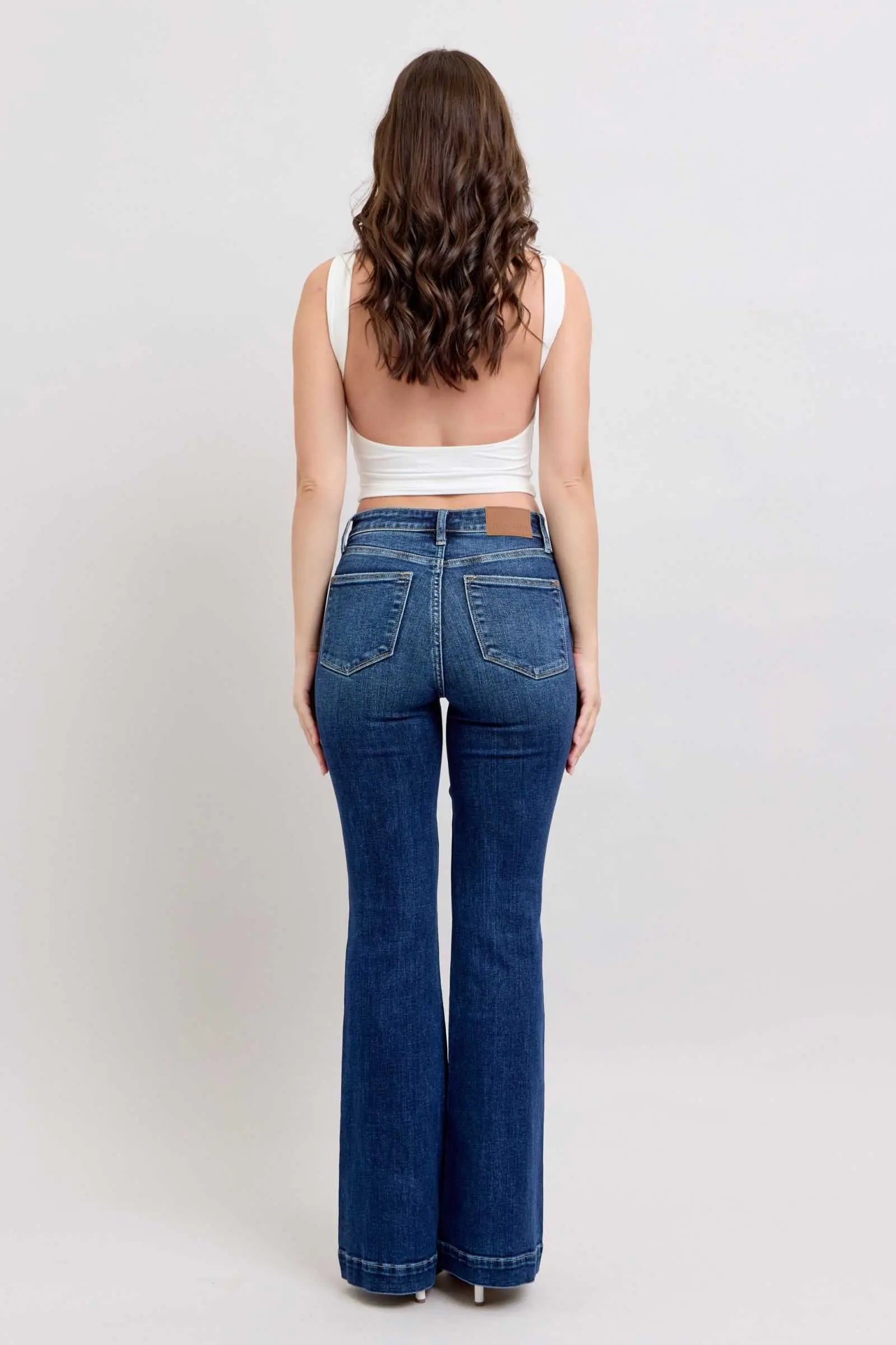 Plus size Judy Blue high rise flare jeans with pockets, back view.