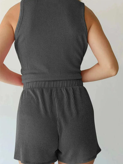 Round neck sleeveless top and shorts set in black, pocketed, slightly stretchy fabric.