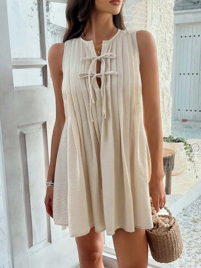 Devine Pleated Sleeveless Mini Dress with tie detail, made of 100% polyester.